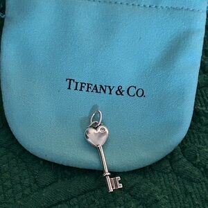 Tiffany & Co. 925 Silver Mini Diamond Heart Key
Pendant. (pouch and box )